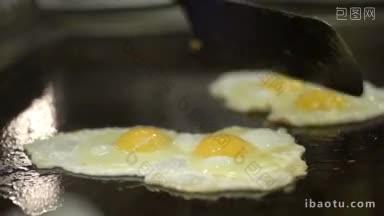 在咖啡馆或餐厅的大炉灶上煎鸡蛋的特写镜头
